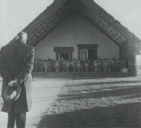 Black and white photo of person standing at marae.