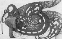 Black and white photo of large wooden carving.